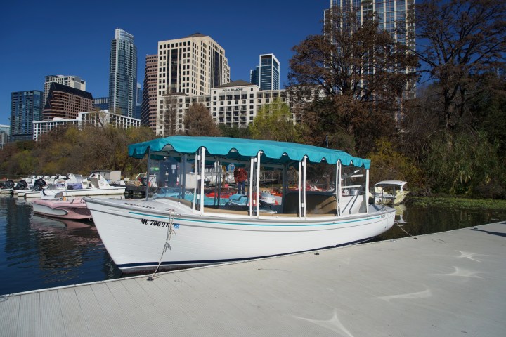 a boat on the water with a city in the background